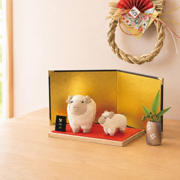 Small Japanese ceramic flower vase displayed with a seasonal branch