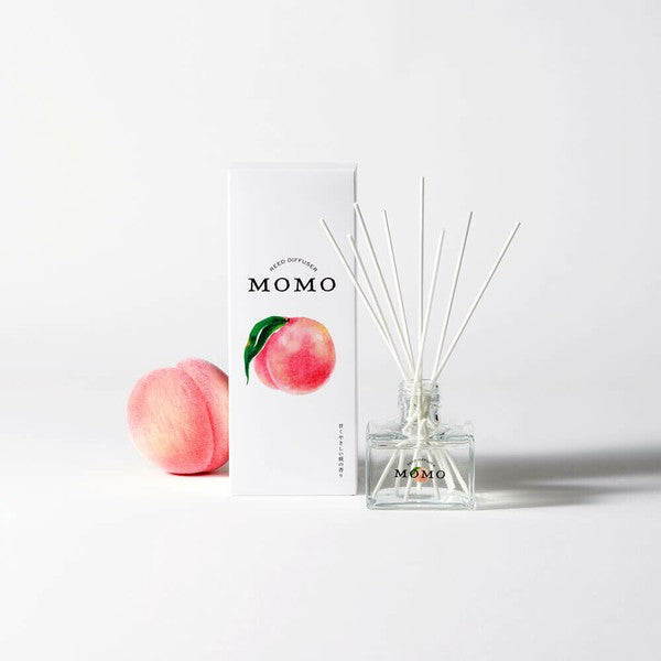 Momo peach reed diffuser lifestyle product image with peach