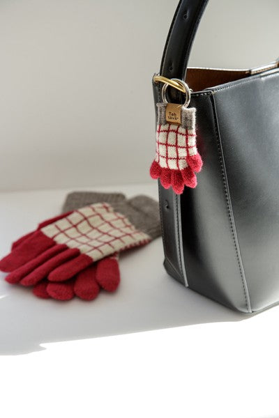 Testava mini glove key charm styled on bag
