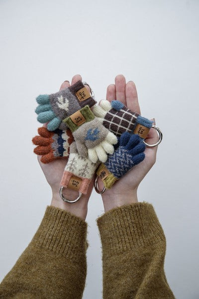 Testava mini glove key charms held in hands