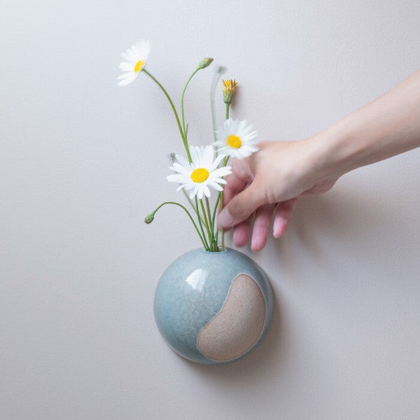 Light Blue Kamakura hanging flower vase displayed with flowers