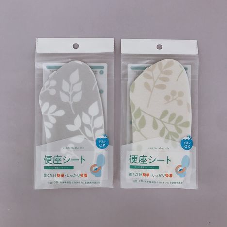 Leaf print washable toilet seat sheets in gray and white packages