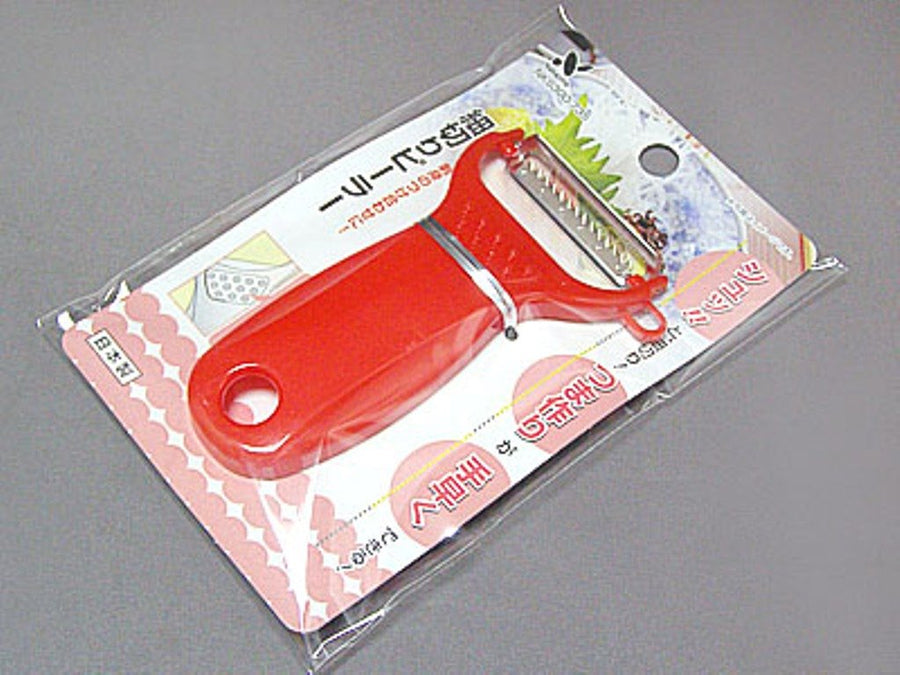 Red Japanese fine julienne peeler with toothed stainless-steel blade