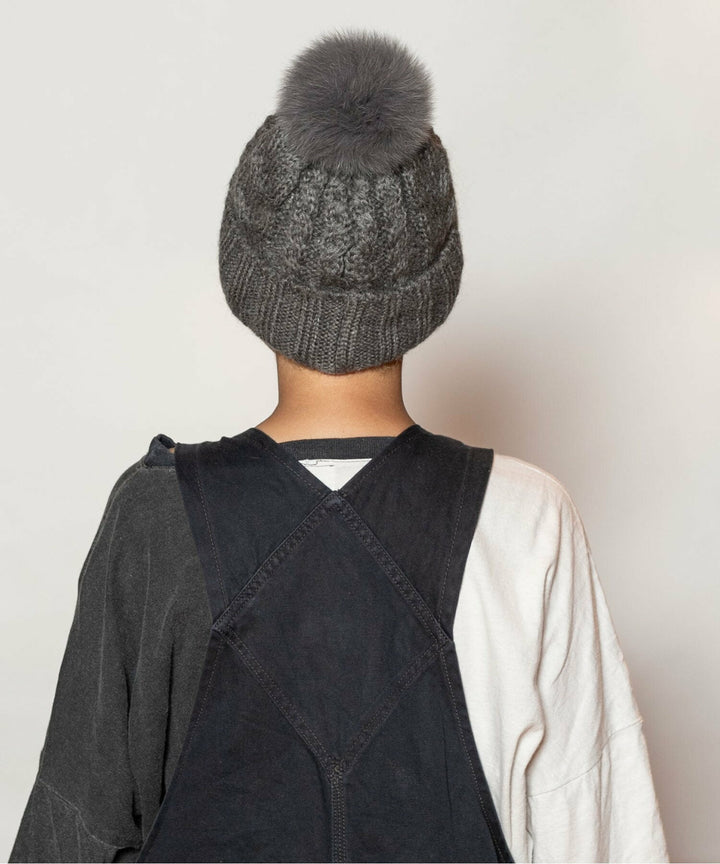 Close-up of CA4LA EX WINTER 6 gray cable knit beanie and fur pom